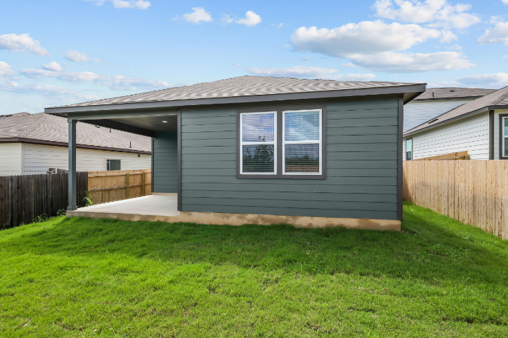 A house with a fence and grass.