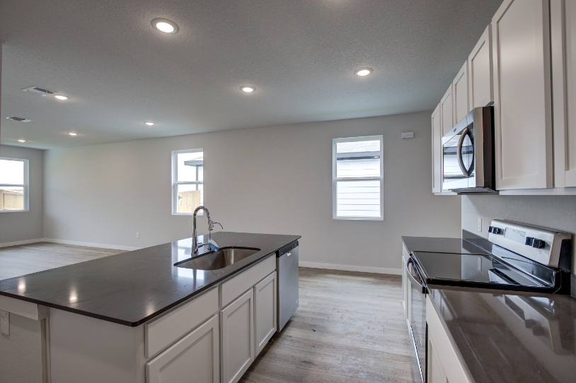 A kitchen with a sink and a stove.