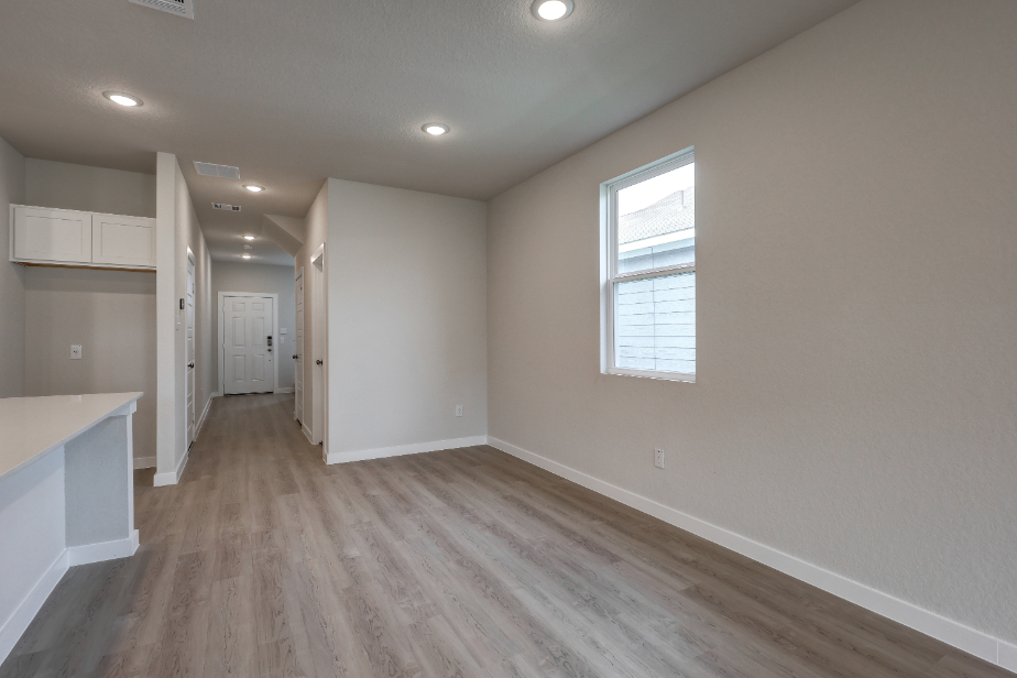 A room with a wood floor and white walls.
