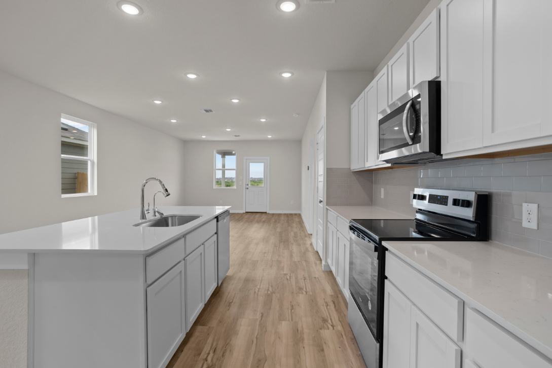 A kitchen with white cabinets.