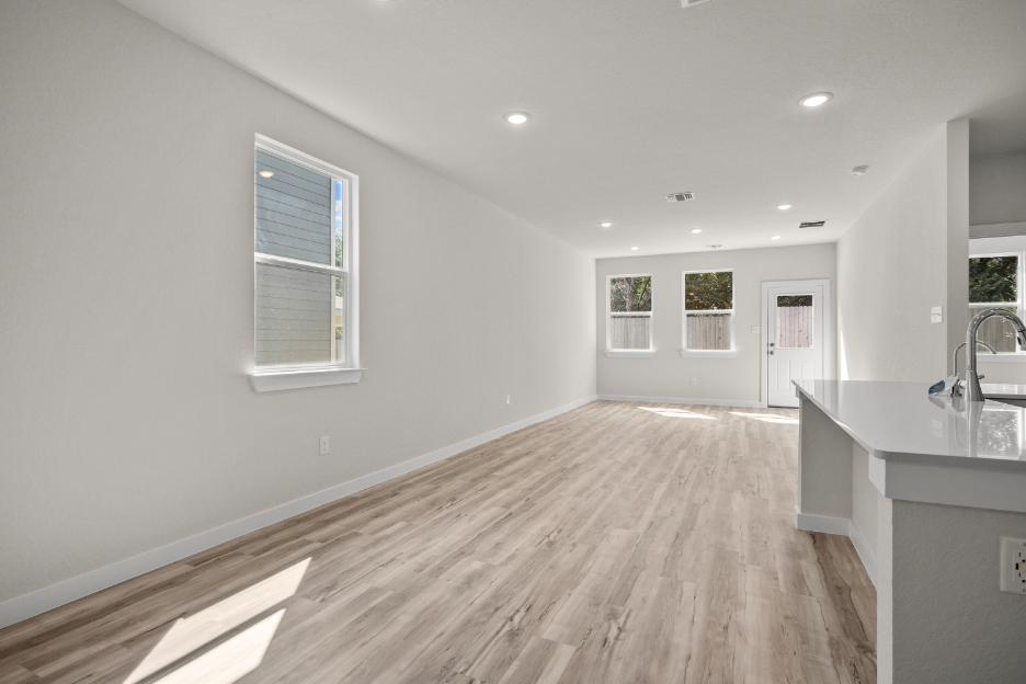 A kitchen with a wood floor.