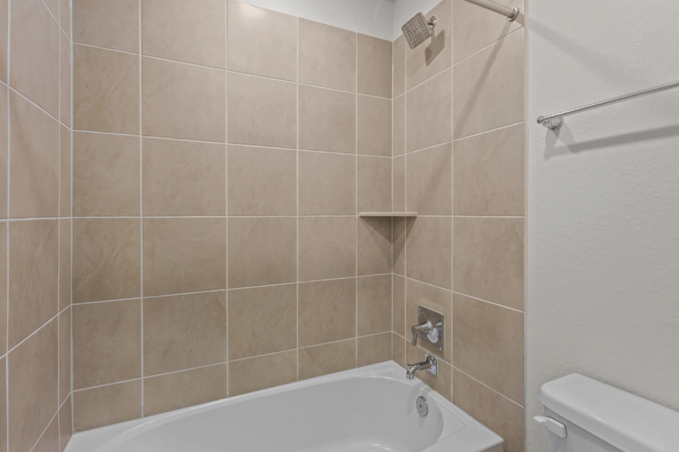 A bathtub in a bathroom.