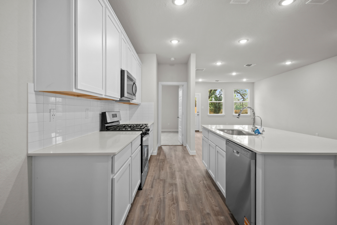 A kitchen with white cabinets.