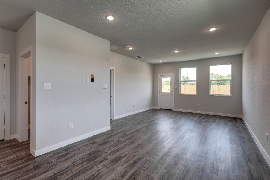 A room with white walls and a wood floor.
