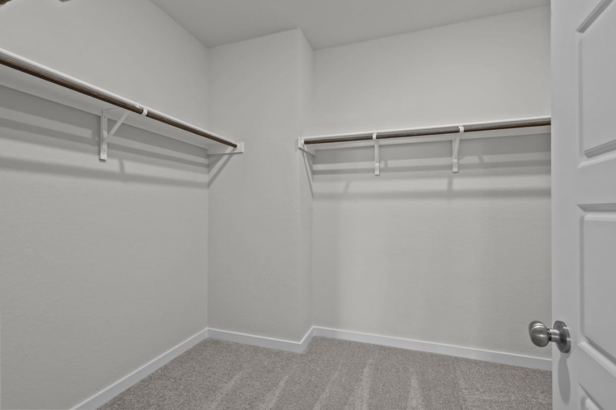 A white room with a metal railing.