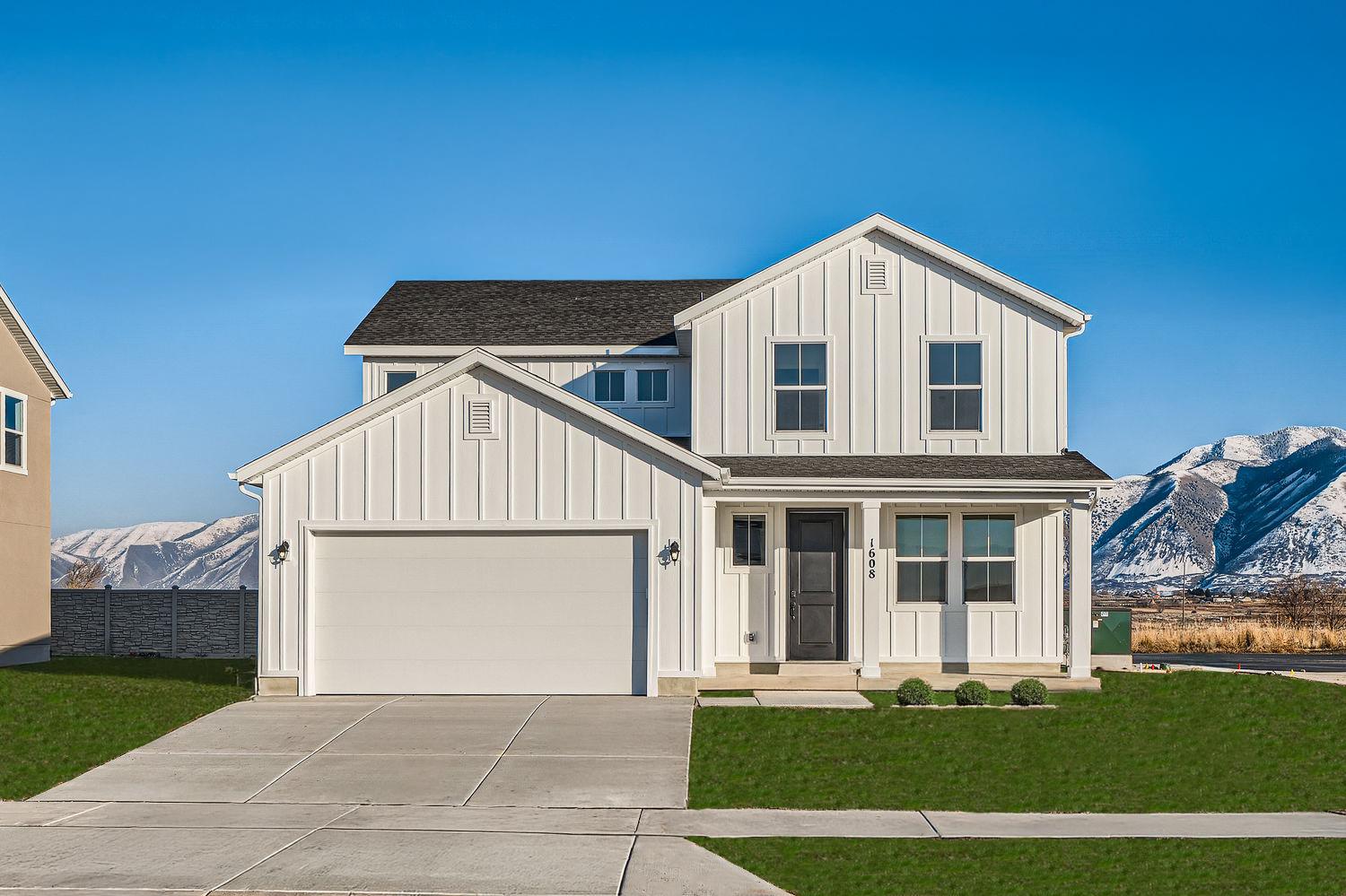 A white house with a mountain in the background.