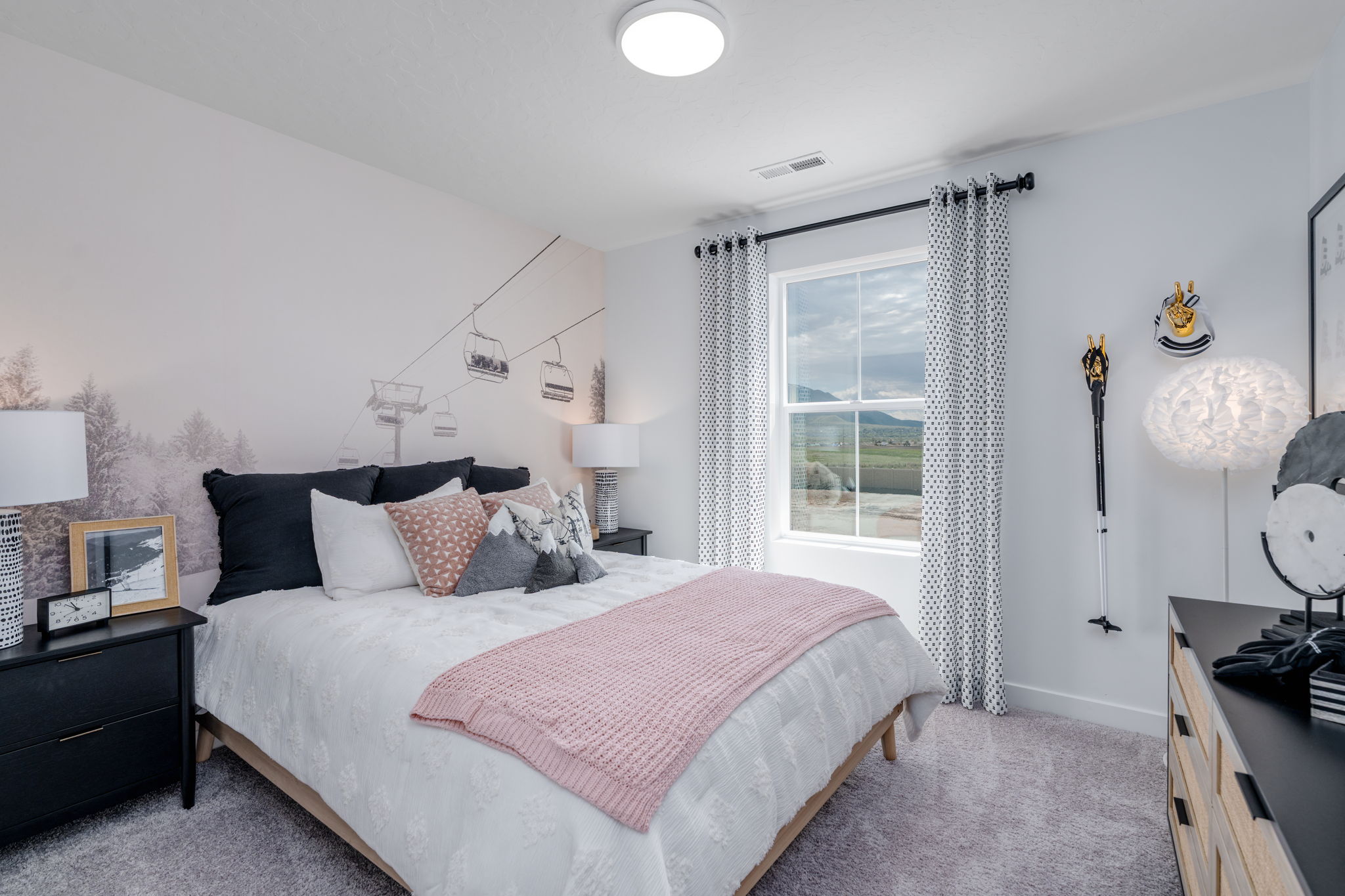 A bedroom with a bed and a window.