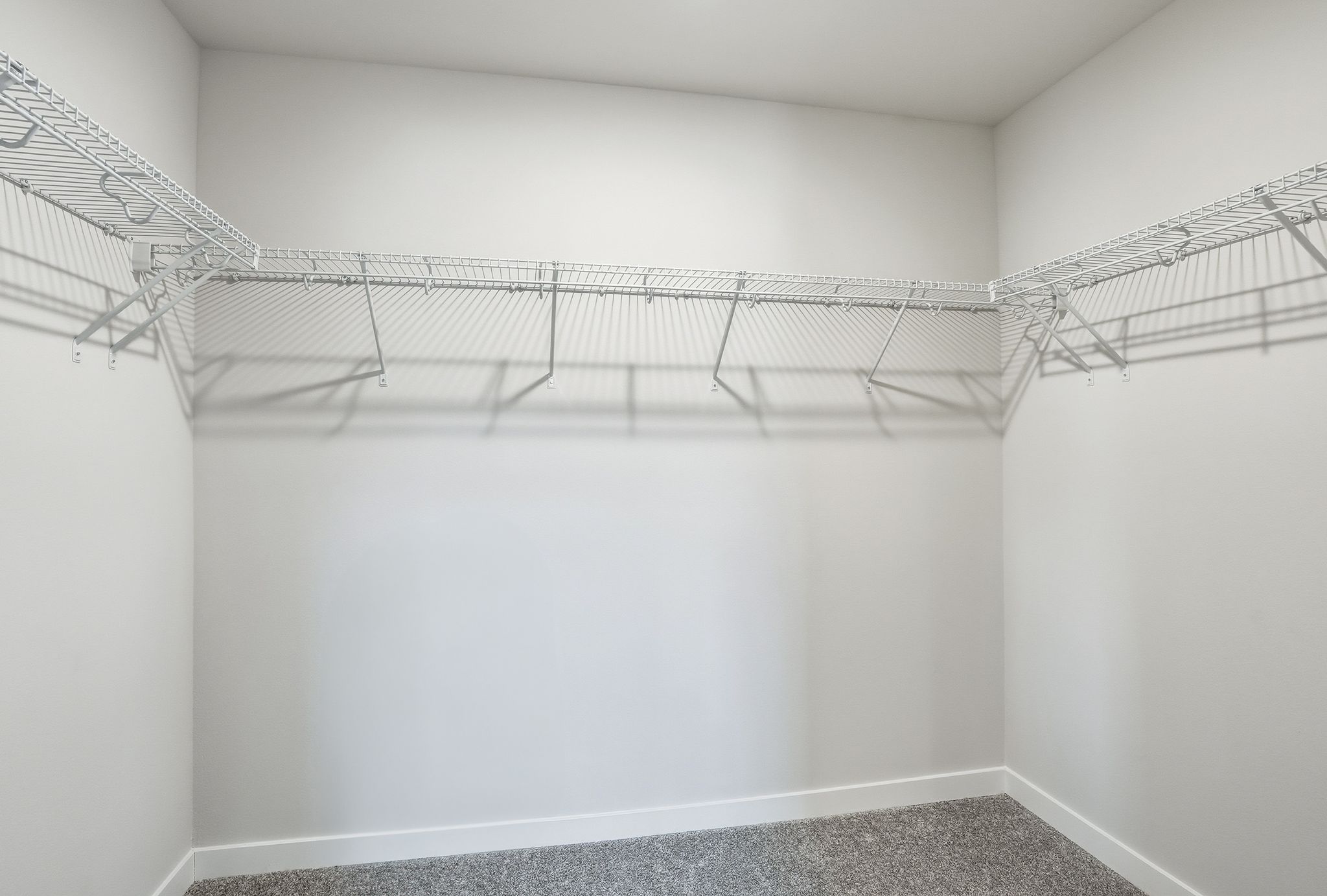 A white room with a metal railing.