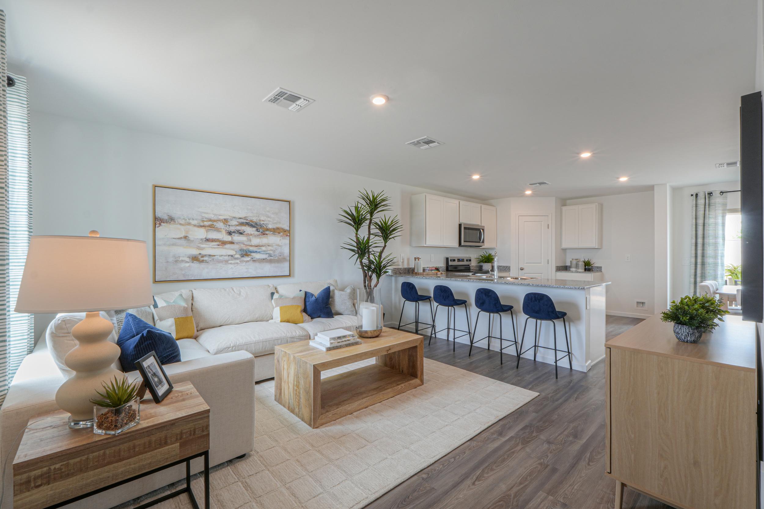 A living room with a couch and chairs.