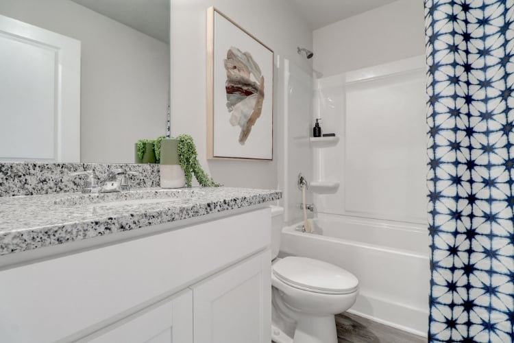 A bathroom with a marble countertop.