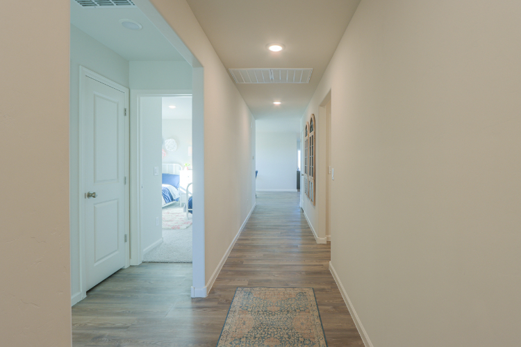A hallway with white doors.