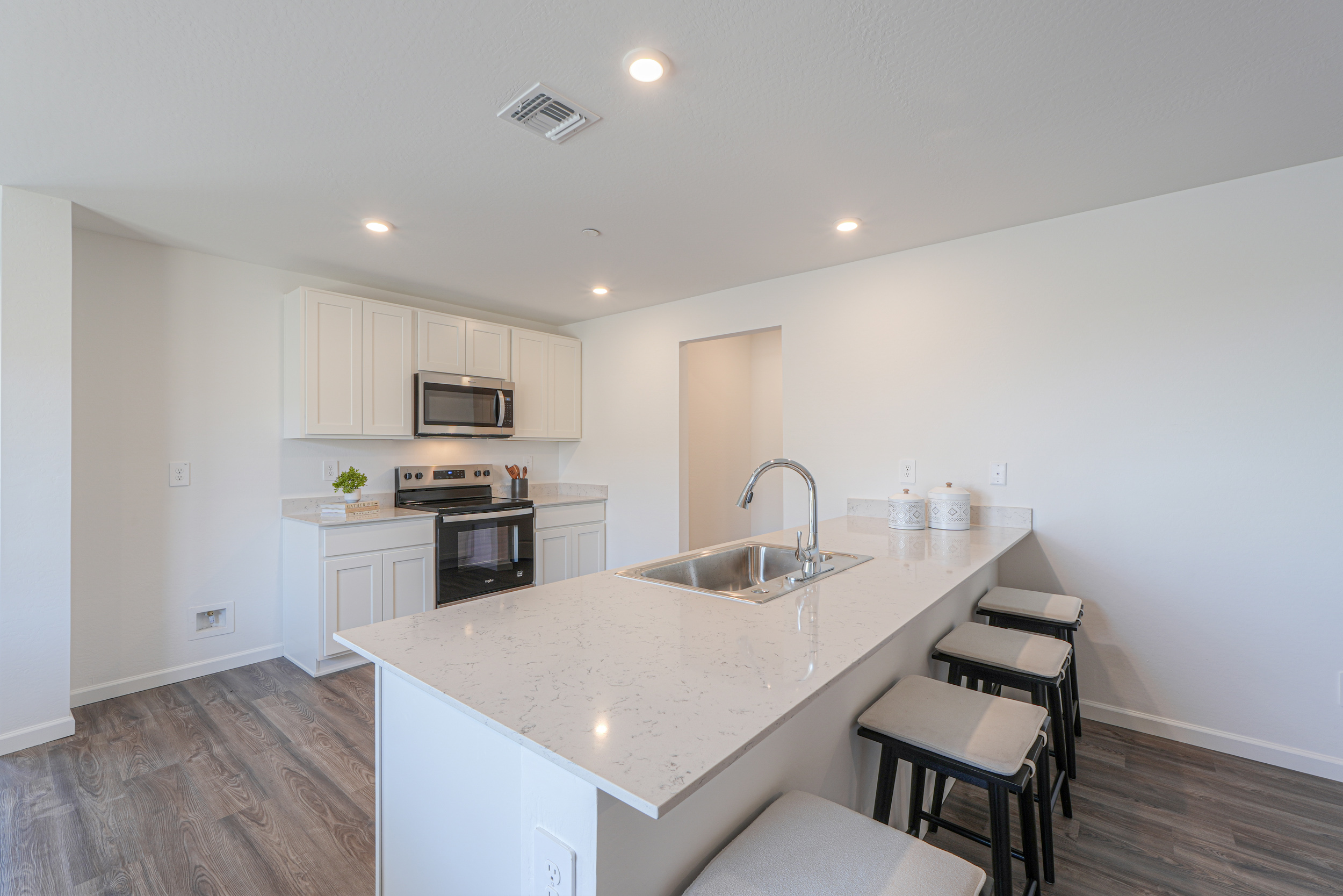 A kitchen with white cabinets.