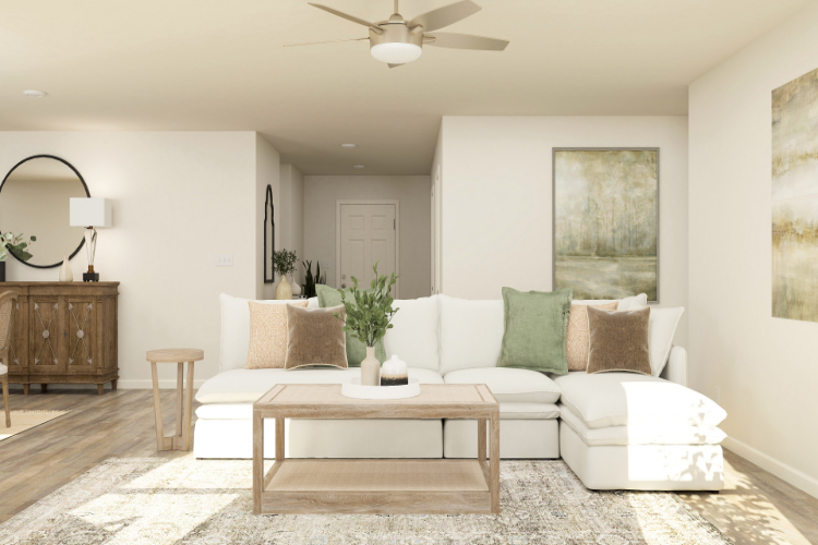 A living room with a white couch and a white table.