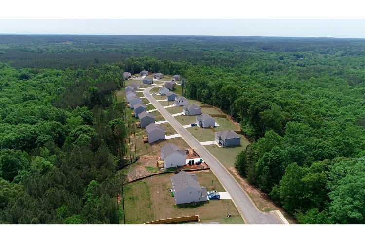 A group of buildings surrounded by trees.