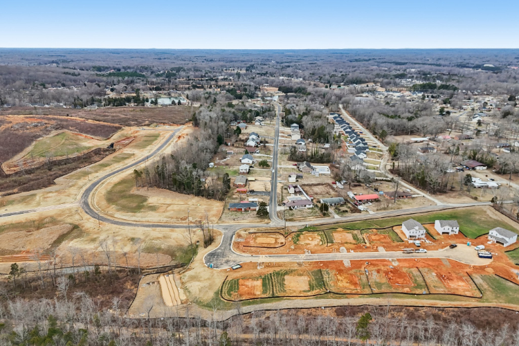 A landscape with a road and buildings.