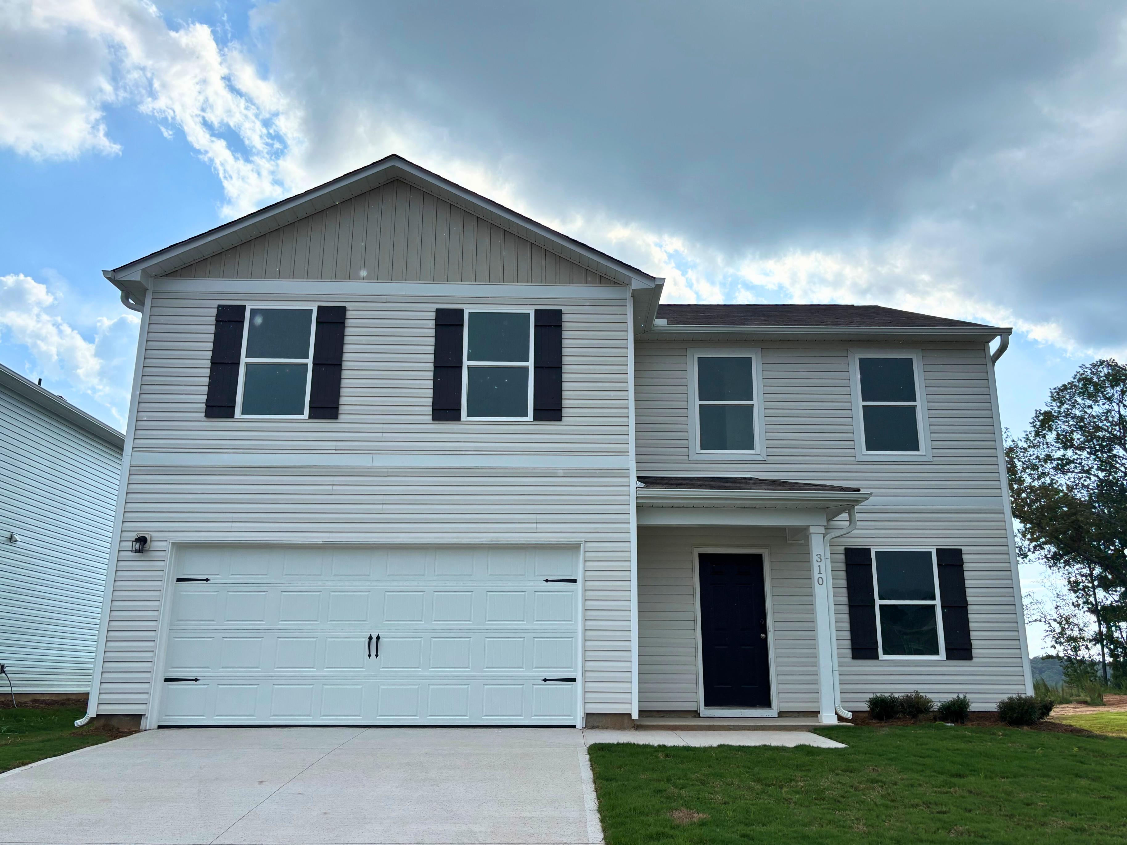A white house with a garage.