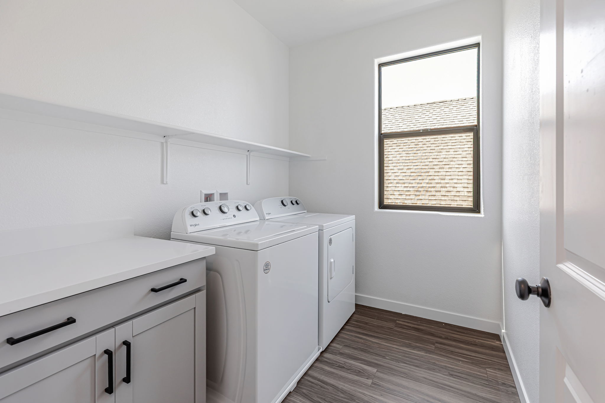 A kitchen with white cabinets.