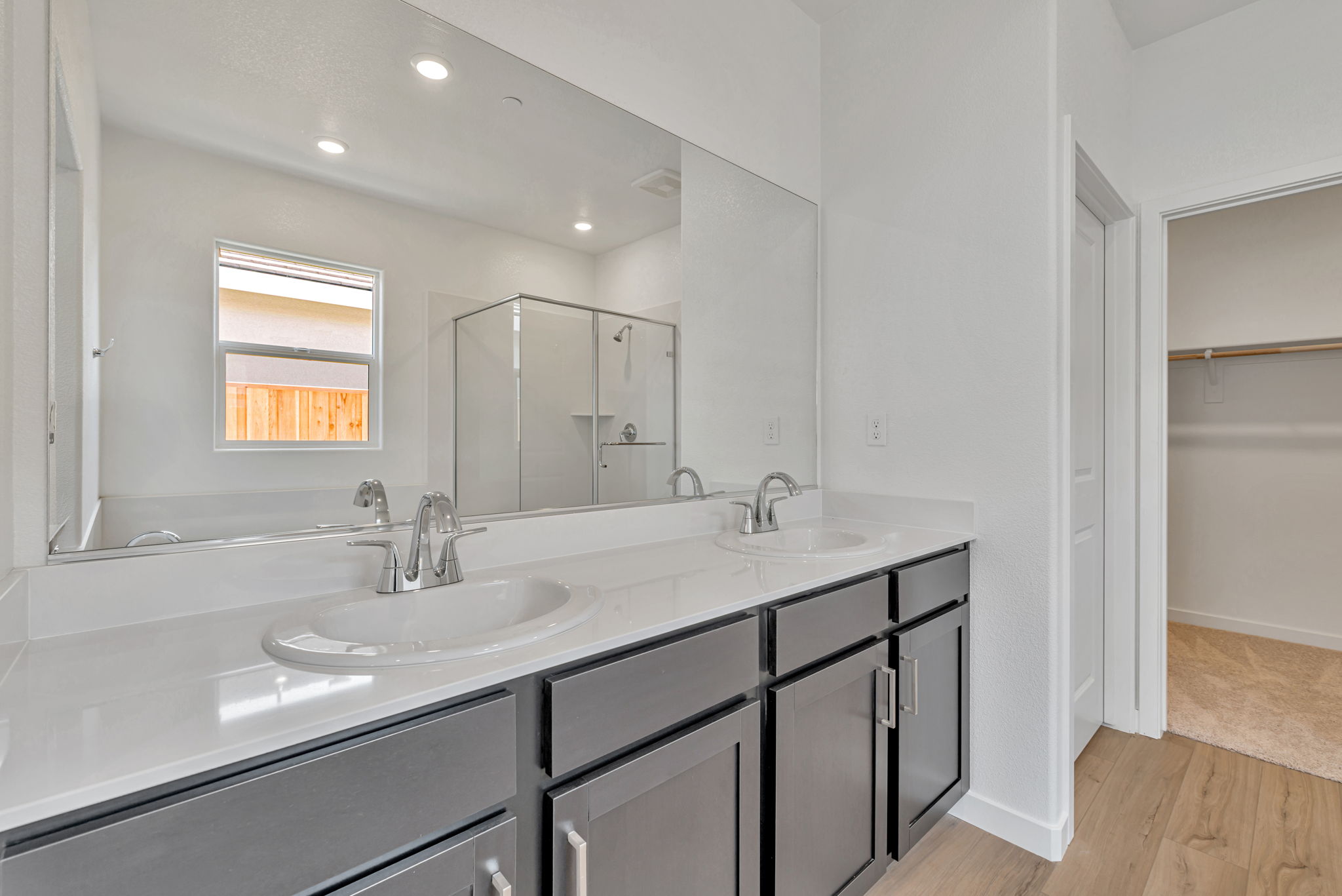 A bathroom with a large mirror.